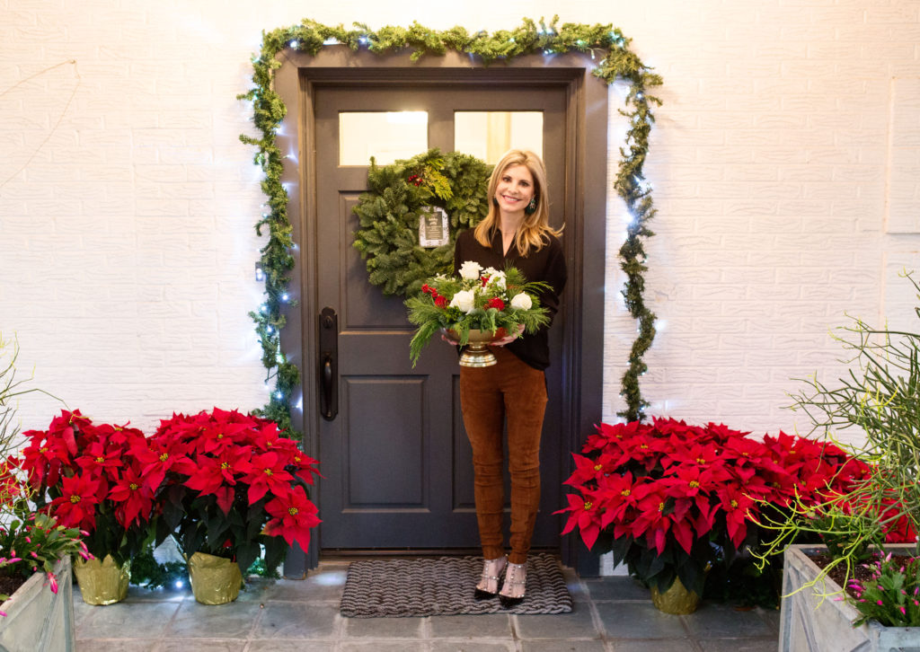 Charcoal front door with holiday greenery